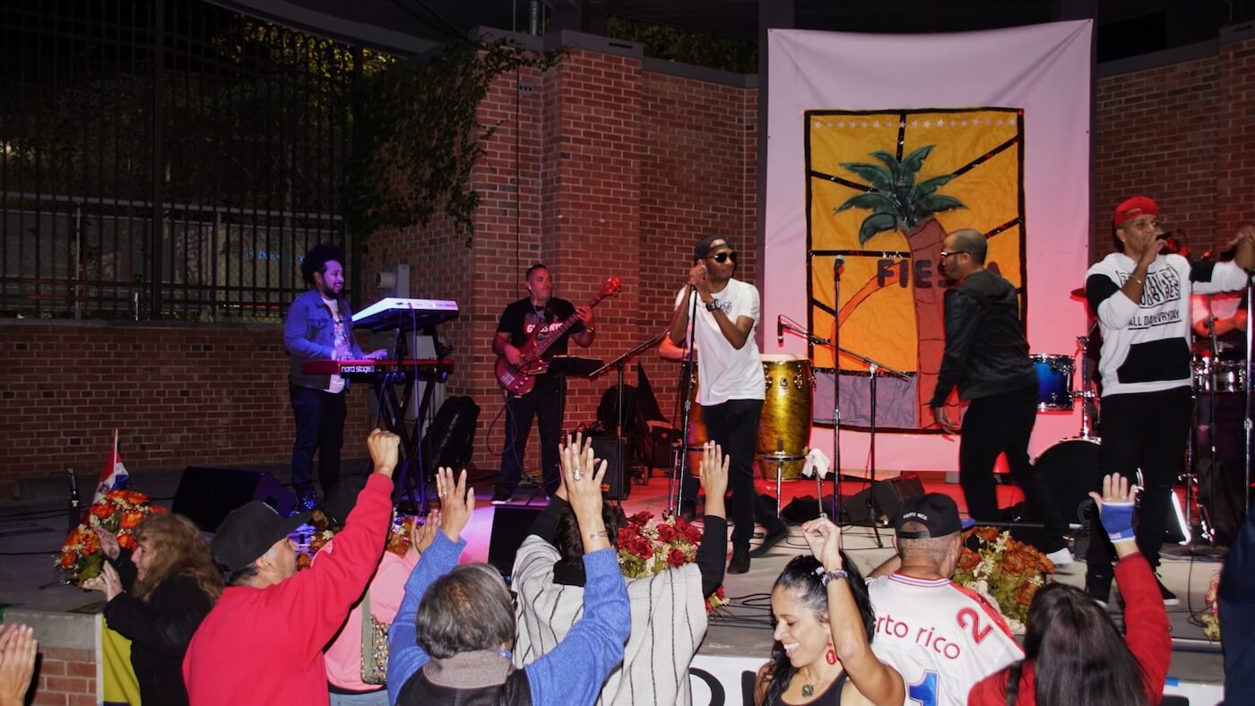 Neighbors gathered at the Raymond Wood Bauer Promenade for a live outdoor event.